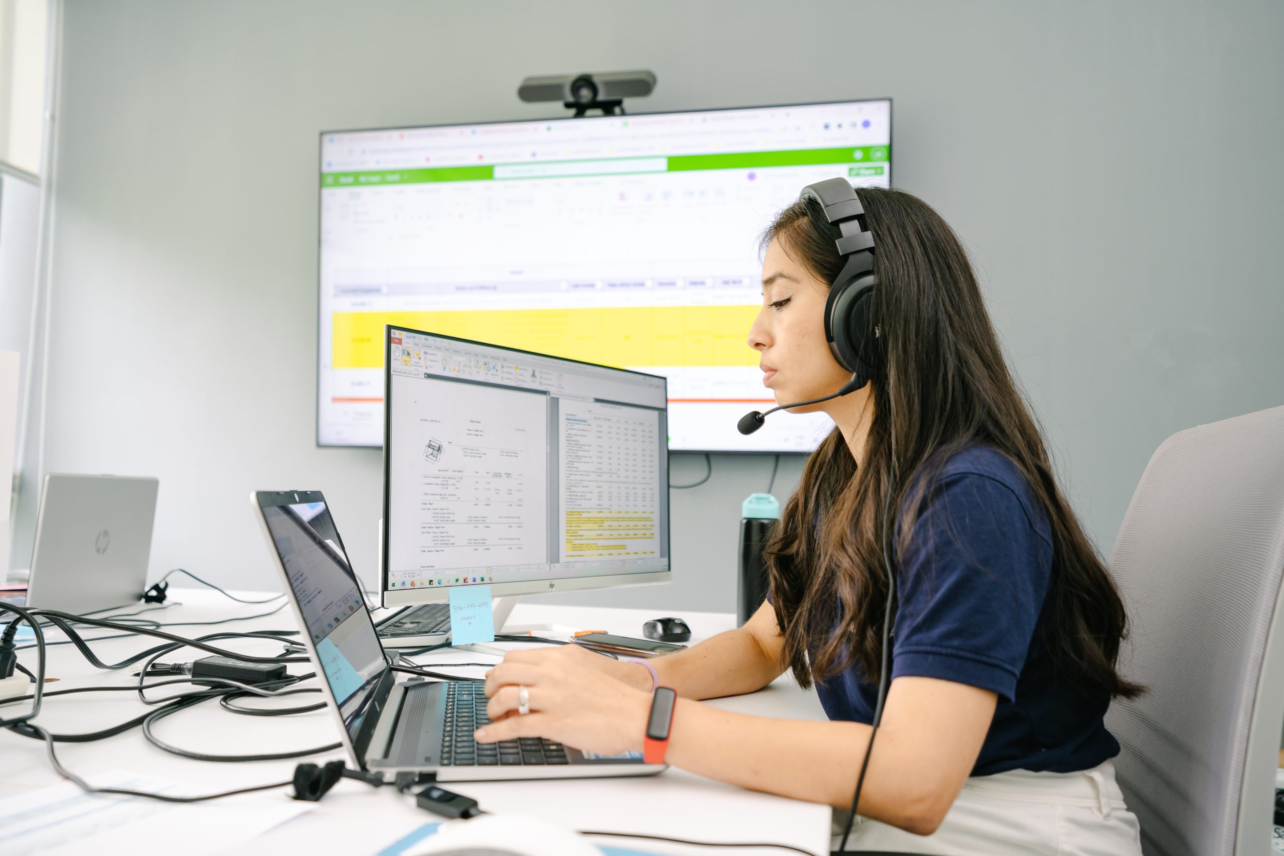 Work Ninjas supplements specialist at a triple-monitor desk